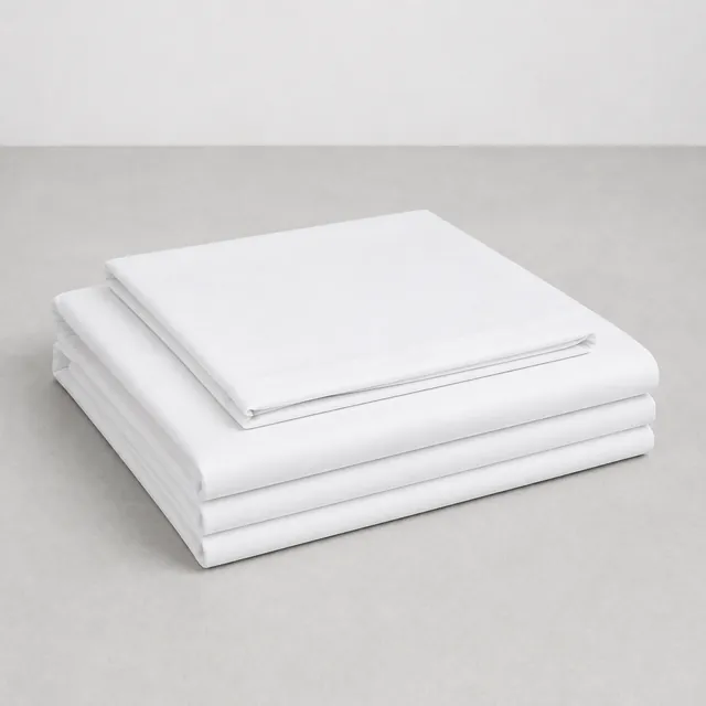 Folded plain white hospital bed sheets