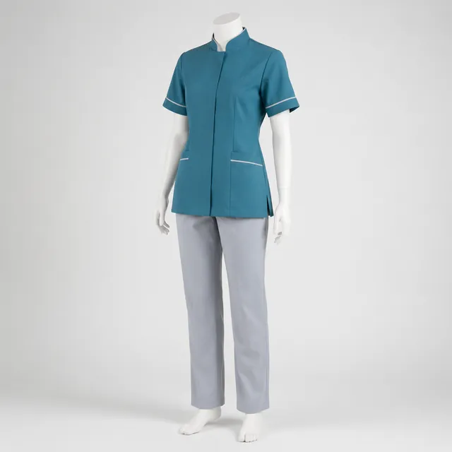 Teal tunic with light grey trousers on a mannequin